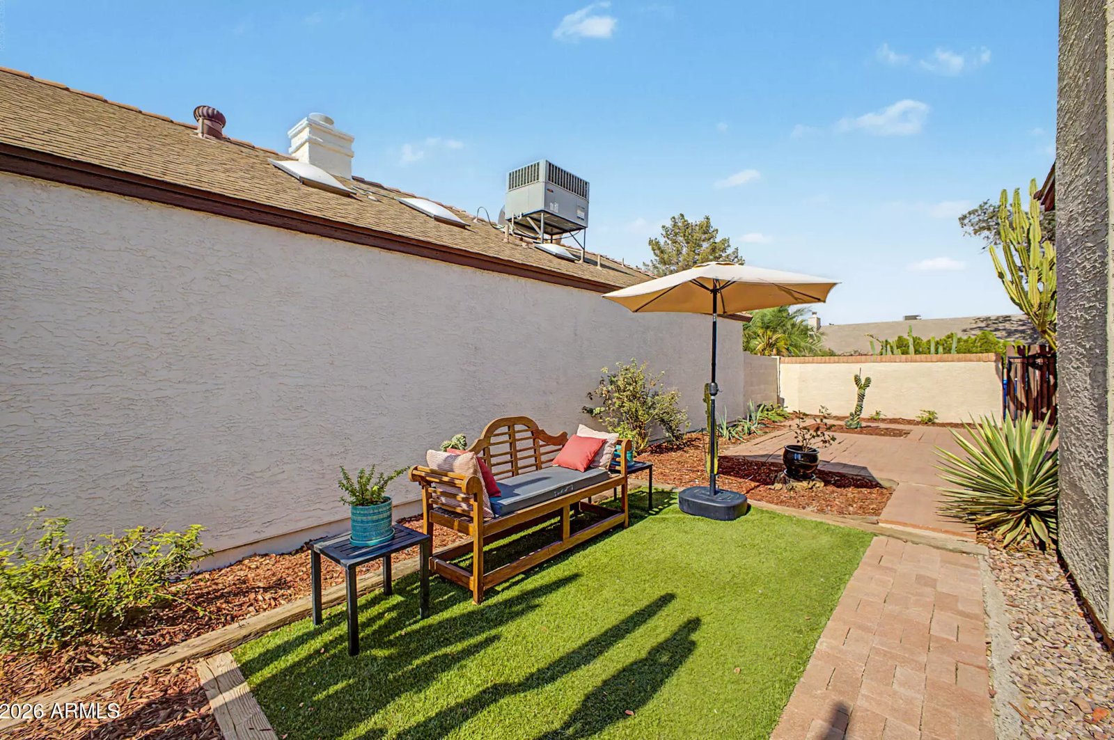 Backyard seating area with turf lawn in a Glendale, Arizona brokerage listing