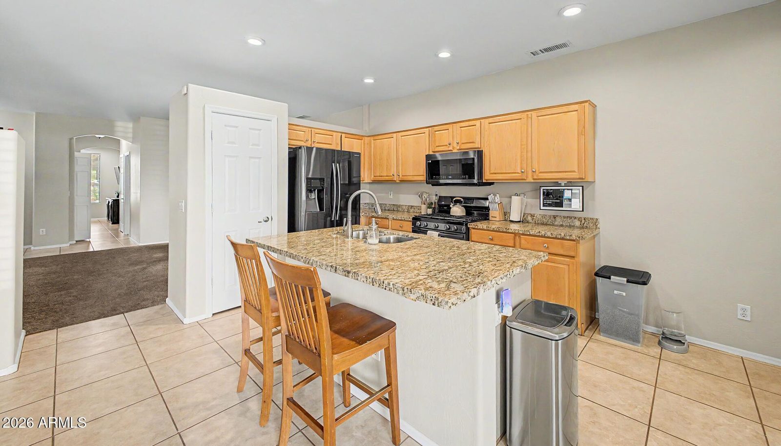 Kitchen with island and pantry at 1820 S 84th Dr in Tolleson, Arizona