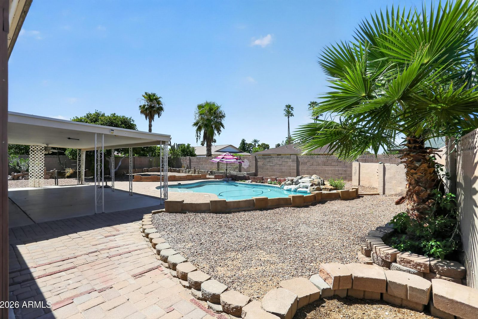Low-maintenance desert landscaping in the rear yard at 10613 W Meade Dr